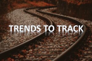 Curved railway tracks surrounded by fallen leaves in autumn.