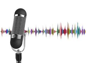 A vintage microphone with colorful sound waves beside it.