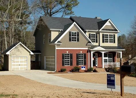 A spacious suburban house with a brick facade and attached garage.