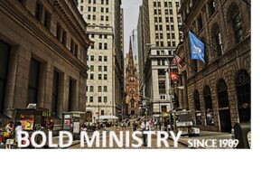 Busy city street with historic church and tall buildings.