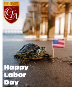 A crab on the beach holding an American flag with 'Happy Labor Day' text.