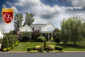 Beautiful suburban house with well-manicured lawn under a cloudy sky.