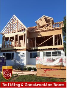 Two-story house under construction with wooden framework and concrete base.