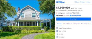 Charming white two-story house with a well-kept lawn and greenery.