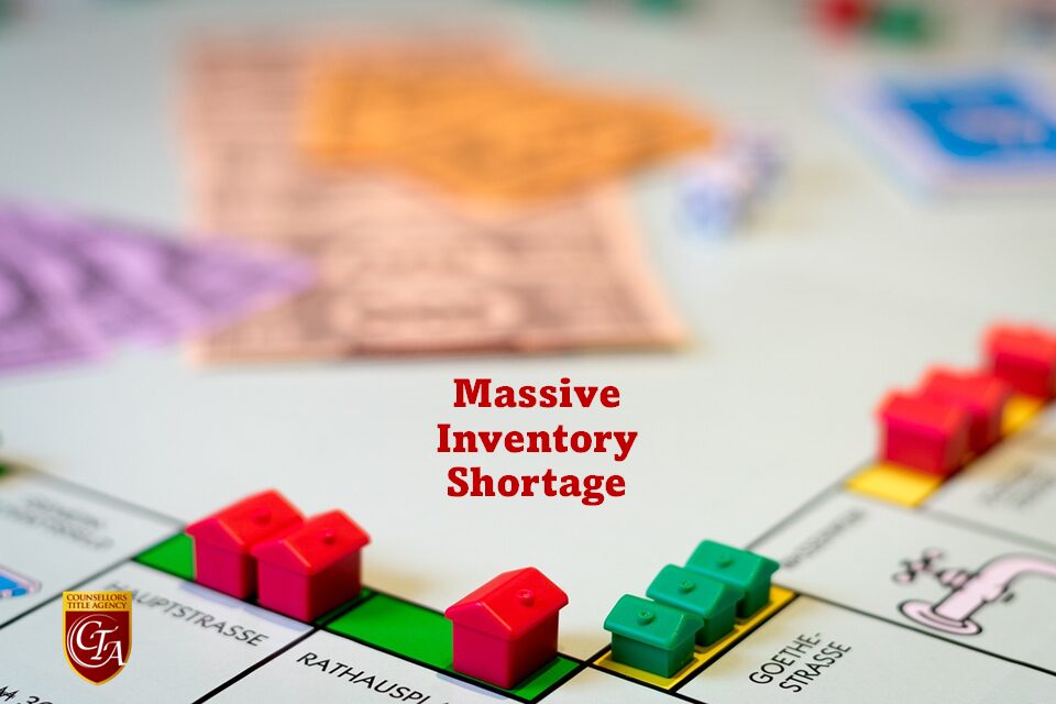 A board game with a 'Massive Inventory Shortage' sign and colorful houses on properties.