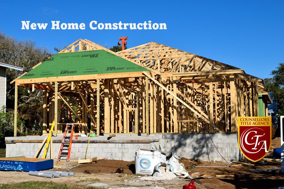 Wooden frame of a house under construction on a sunny day.
