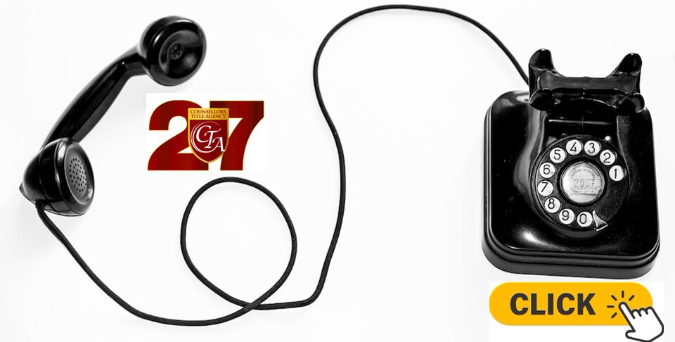 Black wired earphones connected to a small device on a white surface.