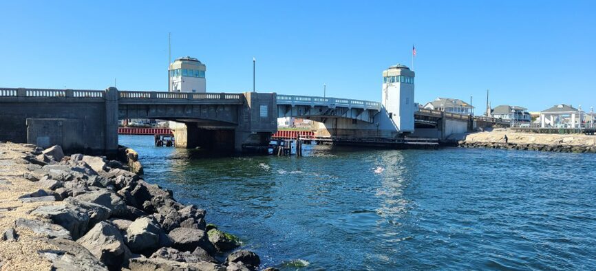 A drawbridge over a body of water with clear skies.