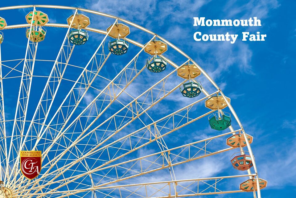 Colorful Ferris wheel cabins against a blue sky at Monmouth County Fair.