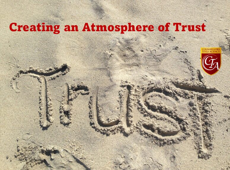 The word 'Trust' written in sand with a message about building trust.