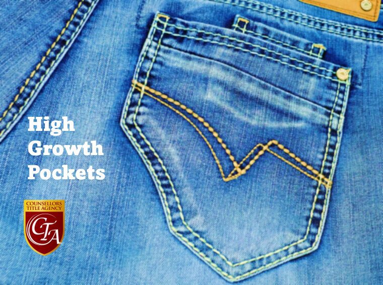 Close-up of a blue denim jeans back pocket with yellow stitching.