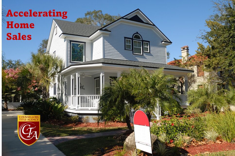 A beautiful white house with a wraparound porch and greenery.