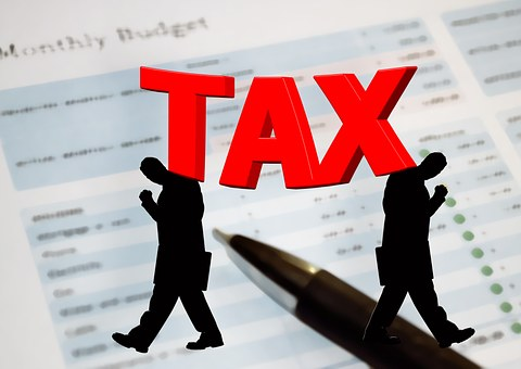 Tax concept with silhouettes and document background.