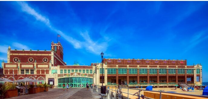 Historic boardwalk building under clear blue sky.