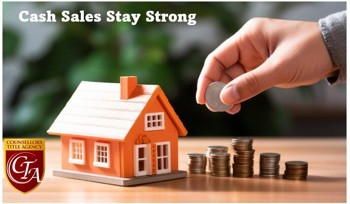 Hand stacking coins beside small house model.