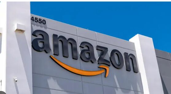 Amazon logo on a building under a clear blue sky.