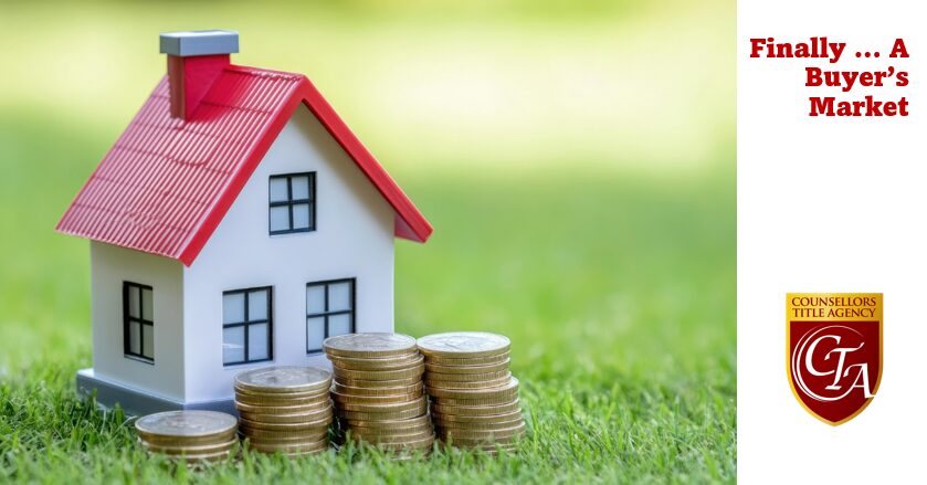 Toy house with stacked coins nearby.